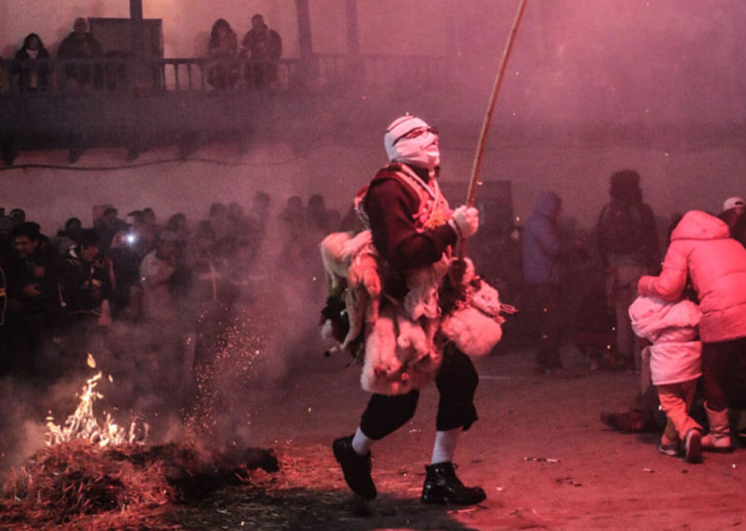 A man in costume walking through the fire.