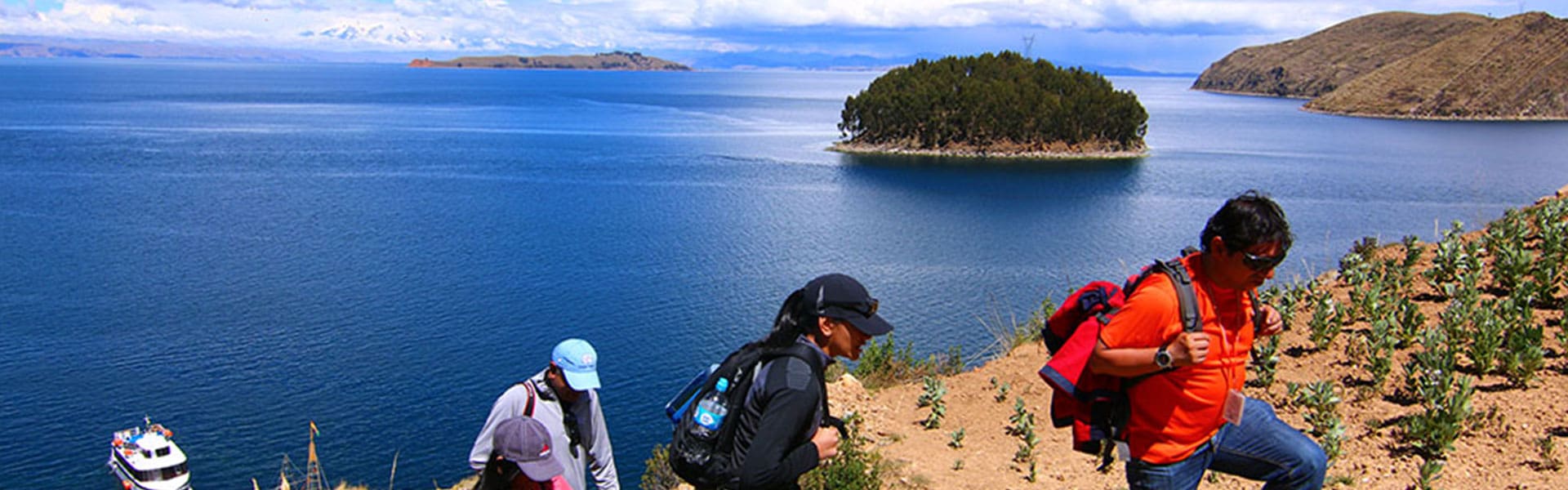 A group of people standing on top of a hill.