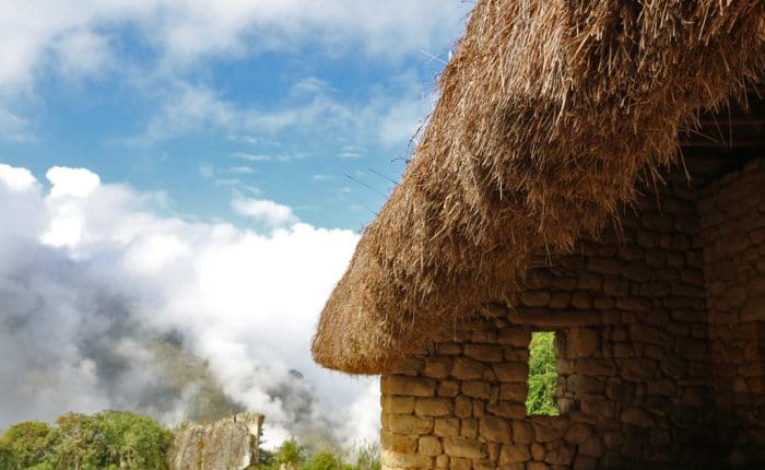 A straw hut with a sky background