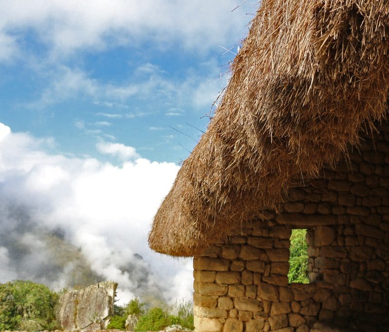 A straw hut with a sky background