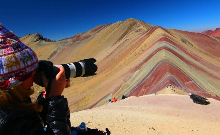 A person taking pictures of the rainbow mountains