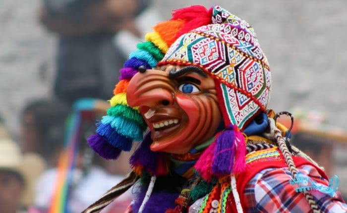 A person with a colorful mask on and some other people