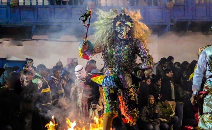 A person in costume is standing on fire.