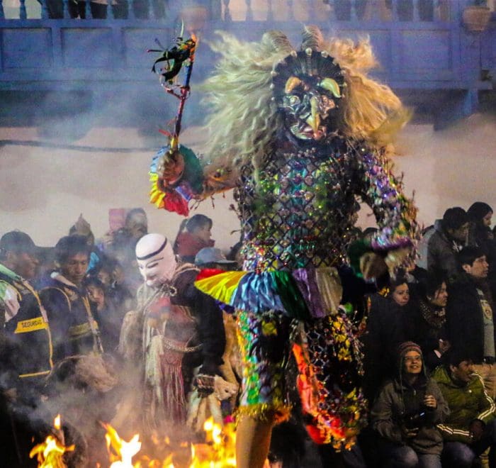 A person in costume is standing on fire.