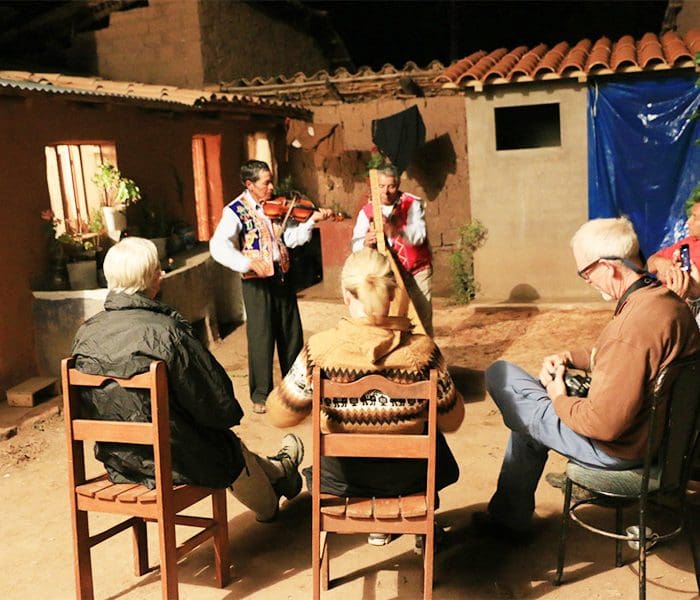 A group of people sitting on chairs playing instruments.