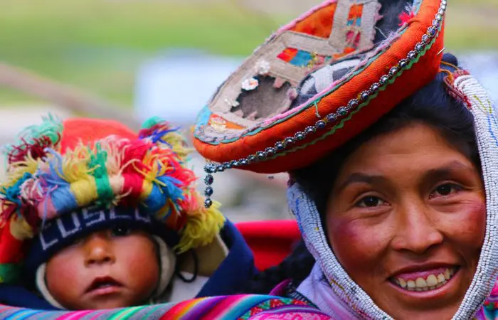 A woman and child wearing colorful hats.