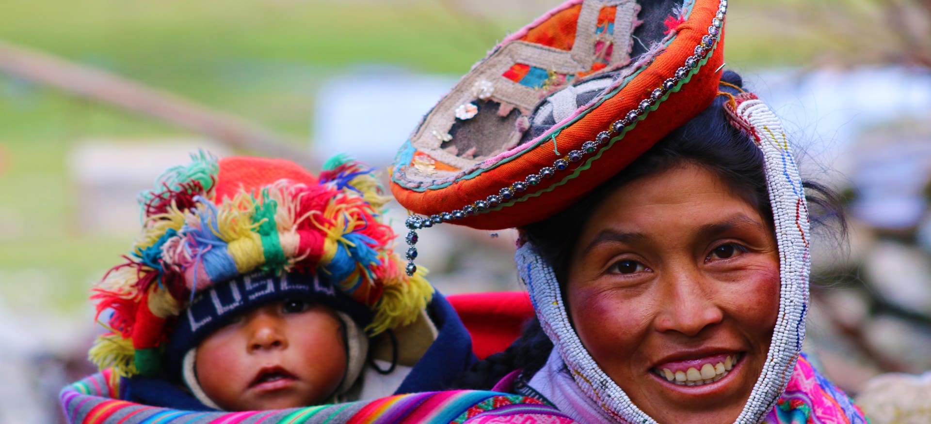 A woman and child wearing colorful hats.