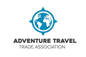 A blue globe with the words adventure travel trade association underneath.
