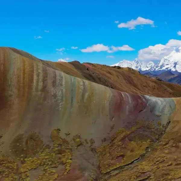 A mountain with many colors of the ground