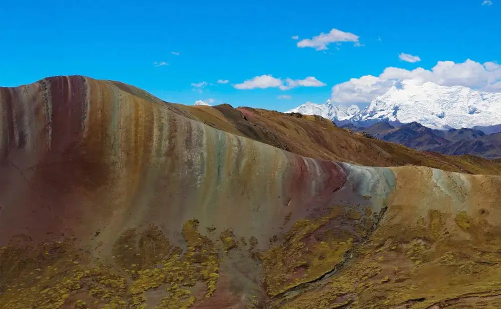 A mountain with many colors of the ground